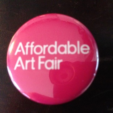 Affordable Art Fair button on brown leather